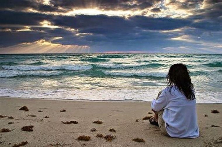 Sad woman by seashore